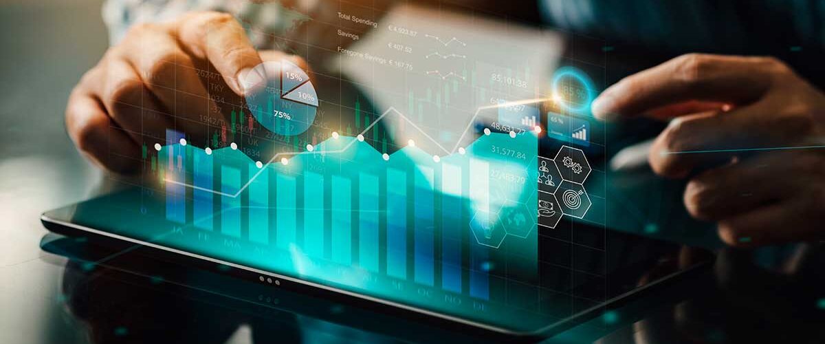 Pessoa utilizando tablet com gráficos digitais, dados e indicadores financeiros representando tecnologia e inteligência artificial no marketing imobiliário.