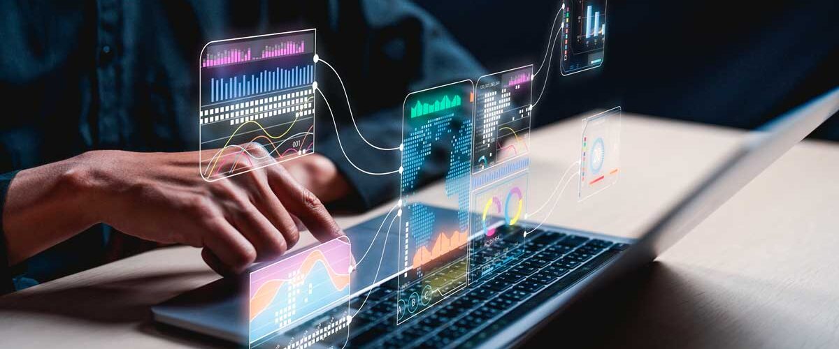 Pessoa usando notebook com gráficos digitais de análise de dados flutuando sobre a tela, simbolizando o uso de inteligência artificial e tecnologia avançada para interpretar informações e tendências no mercado imobiliário.